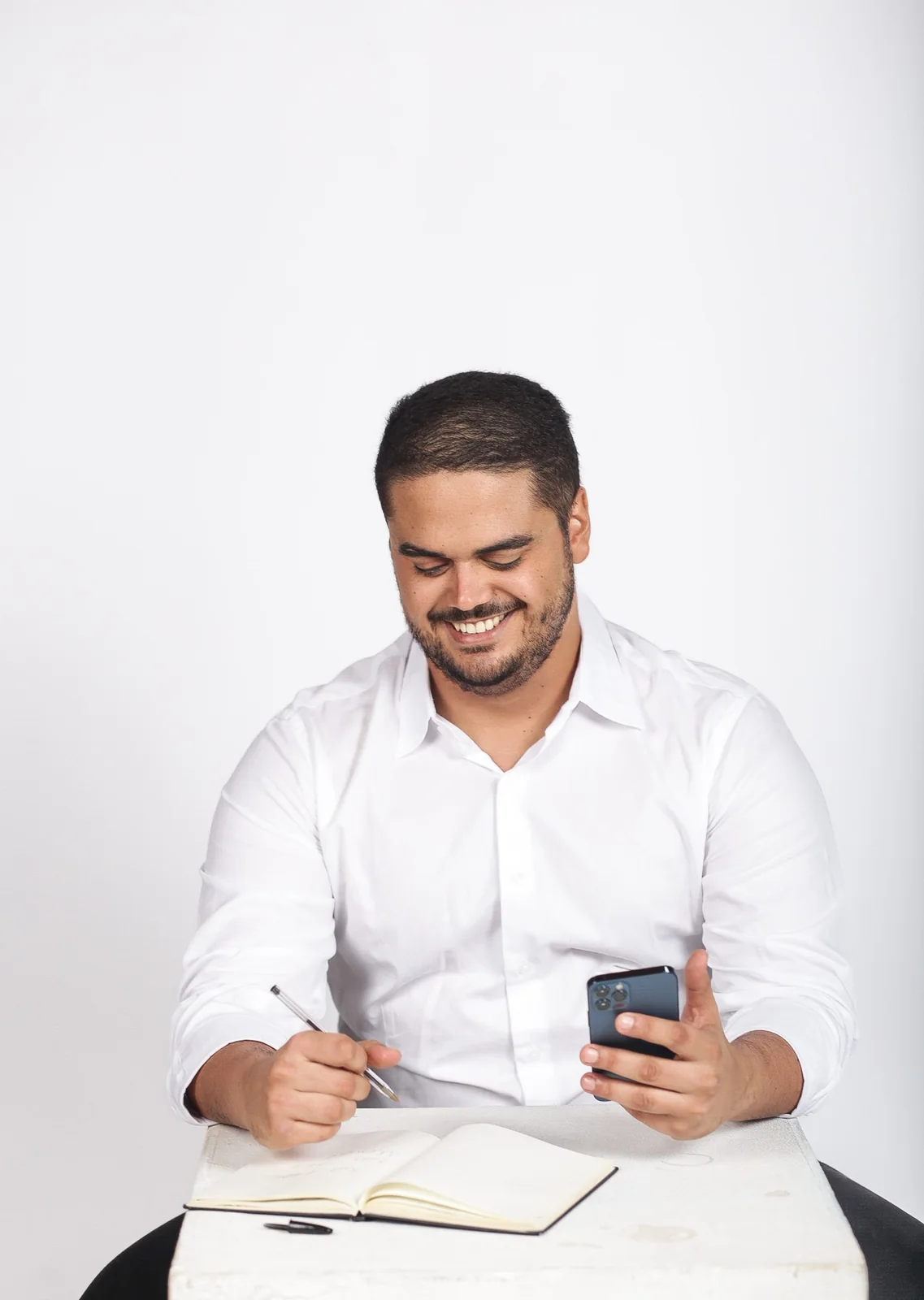 Marco Pedro Sales analisando anotações e celular